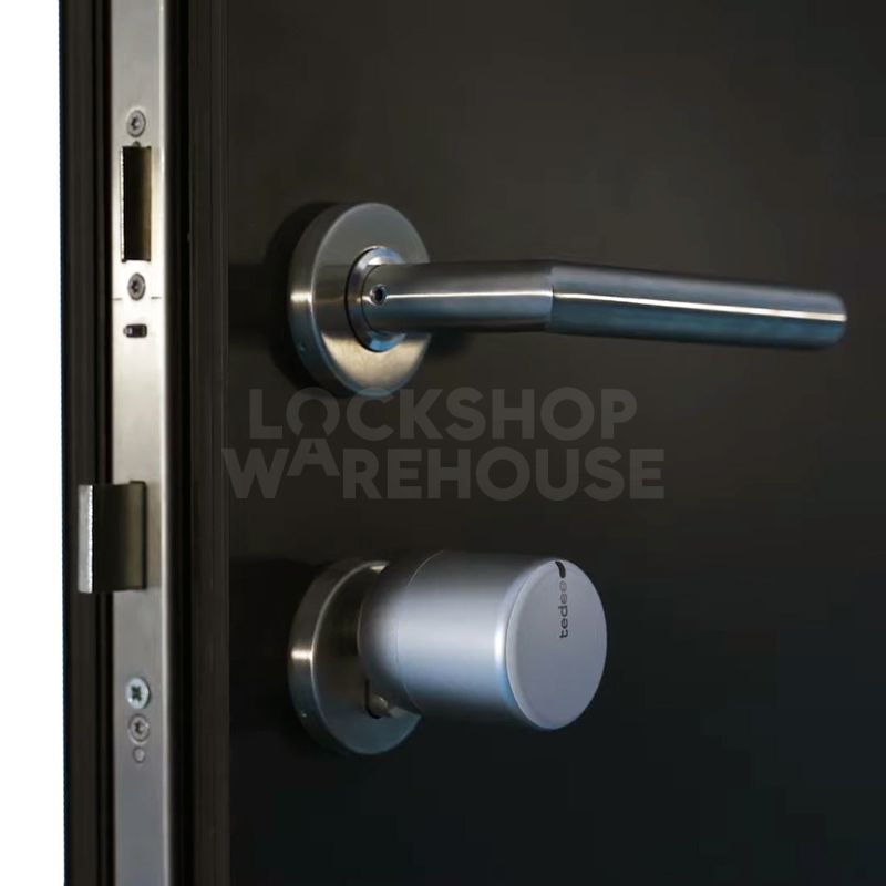 Gallery Image: White Tedee unit fitted below handle on multi-point locking door